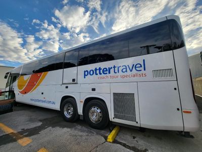 A Potter Travel Bus is Parked in a Parking Lot — Signworld In Mitchell, ACT