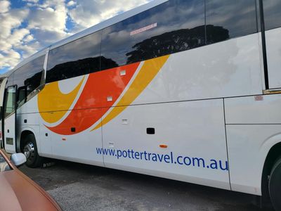 A Potter Travel Bus is Parked in a Parking Lot — Signworld In Mitchell, ACT