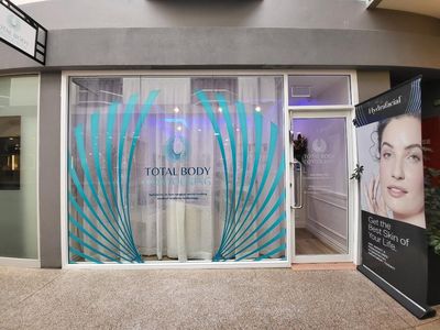 The Front of a Beauty Salon With a Woman 's Face on the Window — Signworld In Mitchell, ACT