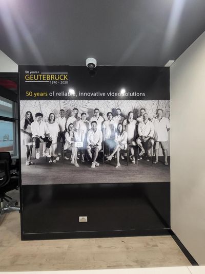 A Group of People Are Standing in Front of a Sign That Says 'Gutebruck' on It — Signworld In Mitchell, ACT