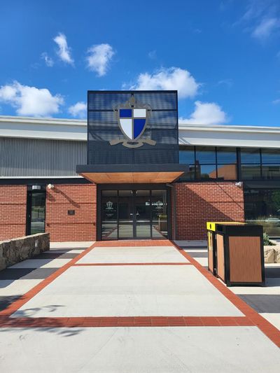 A Large Brick Building With a Shield on Top of It — Signworld In Mitchell, ACT