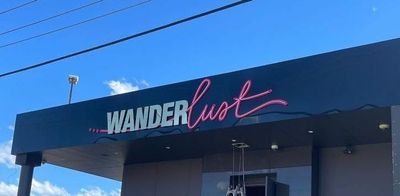 A Building With a Sign That Says Wanderlust on It — Signworld In Mitchell, ACT