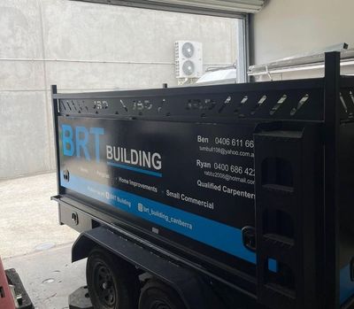 A Dumpster With the Word Building on It is Parked in a Garage — Signworld In Mitchell, ACT