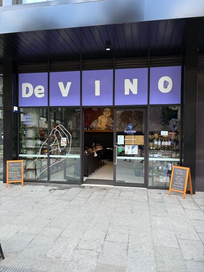 A store front with a purple sign that says de vino — Signworld In Mitchell, ACT