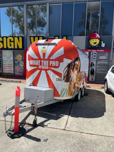 A Trailer That Says What the Pho Express is Parked in Front of a Building — Signworld In Mitchell, ACT