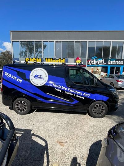 A Black and Blue Van is Parked in Front of a Building — Signworld In Mitchell, ACT