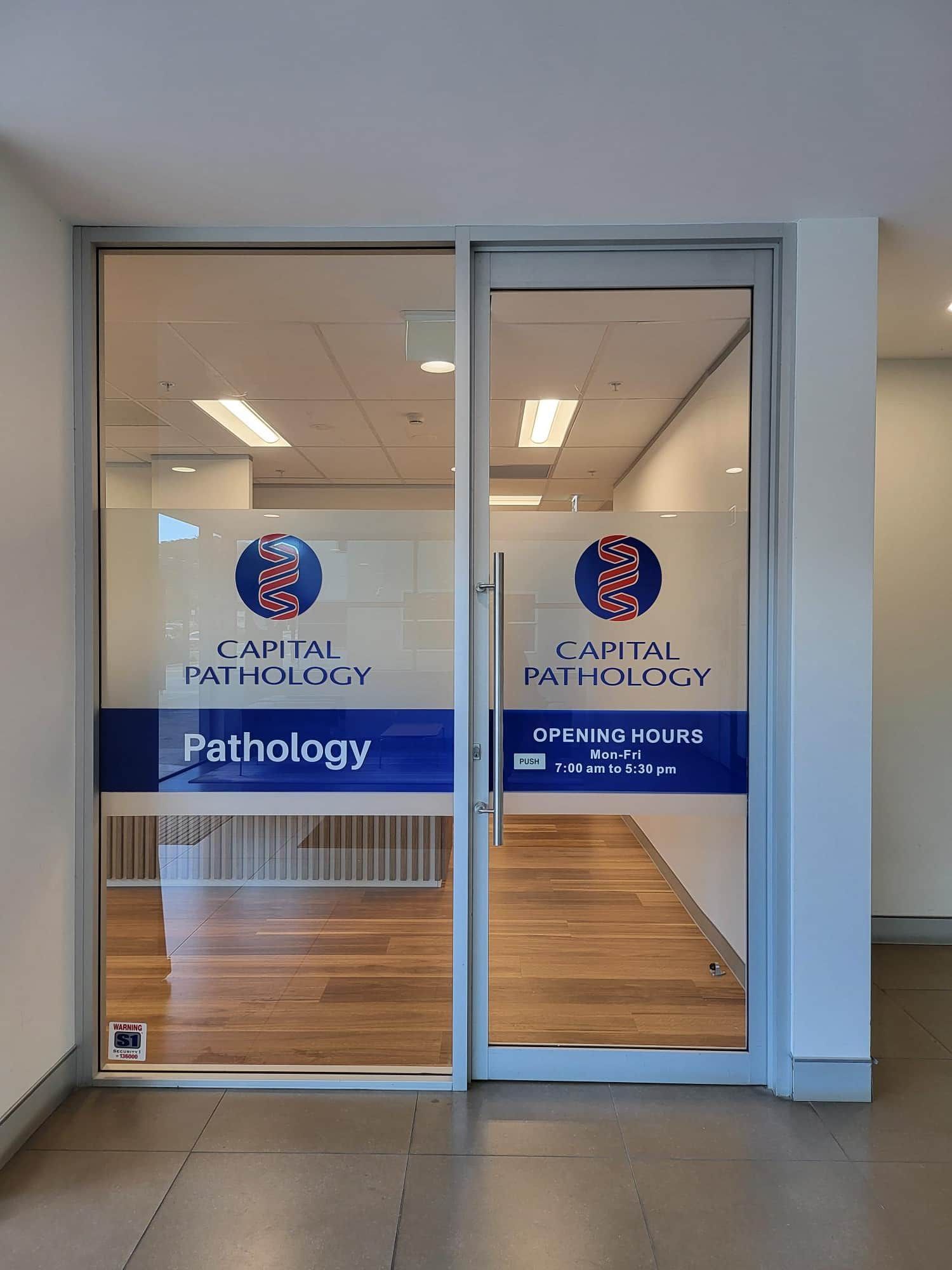 A Glass Door With a Sticker on It That Says Pathology — Signworld In Mitchell, ACT