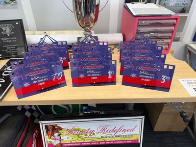 A Table With Trophies and a Sign That Says Rickford — Signworld In Mitchell, ACT