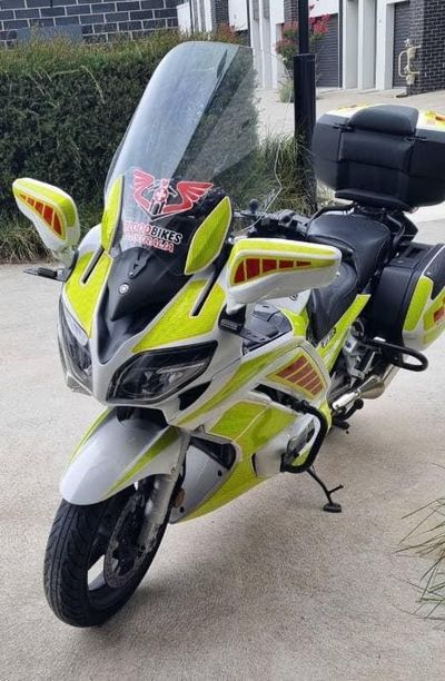 A Yellow and White Motorcycle is Parked on the Side of the Road — Signworld In Mitchell, ACT