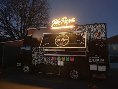 A Food Truck is Parked in Front of a Building at Night — Signworld In Mitchell, ACT