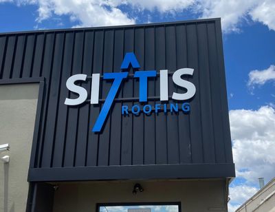 A Sign on the Side of a Building That Says Si Tis Roofing— Signworld In Mitchell, ACT