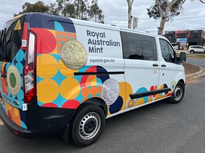 A Royal Australian Mint Van is Parked on the Side of the Road — Signworld In Mitchell, ACT