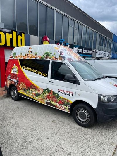 A White Van With a Red and Yellow Wrap is Parked in Front of a Building — Signworld In Mitchell, ACT