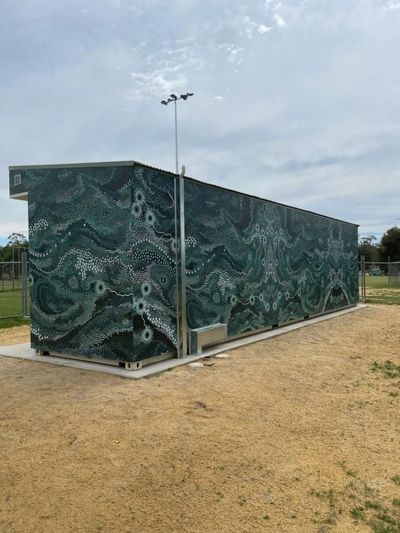 A Large Green Building is Sitting in the Middle of a Dirt Field — Signworld In Mitchell, ACT