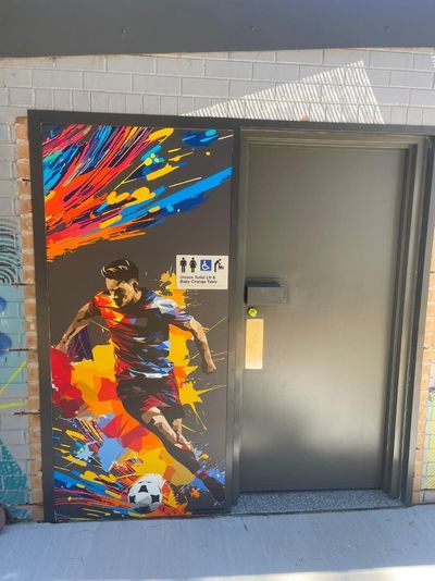 A Door With a Painting of a Soccer Player on It — Signworld In Mitchell, ACT