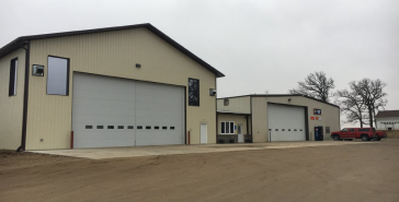 A large building with a red truck parked in front of it | Keck's Repair Inc