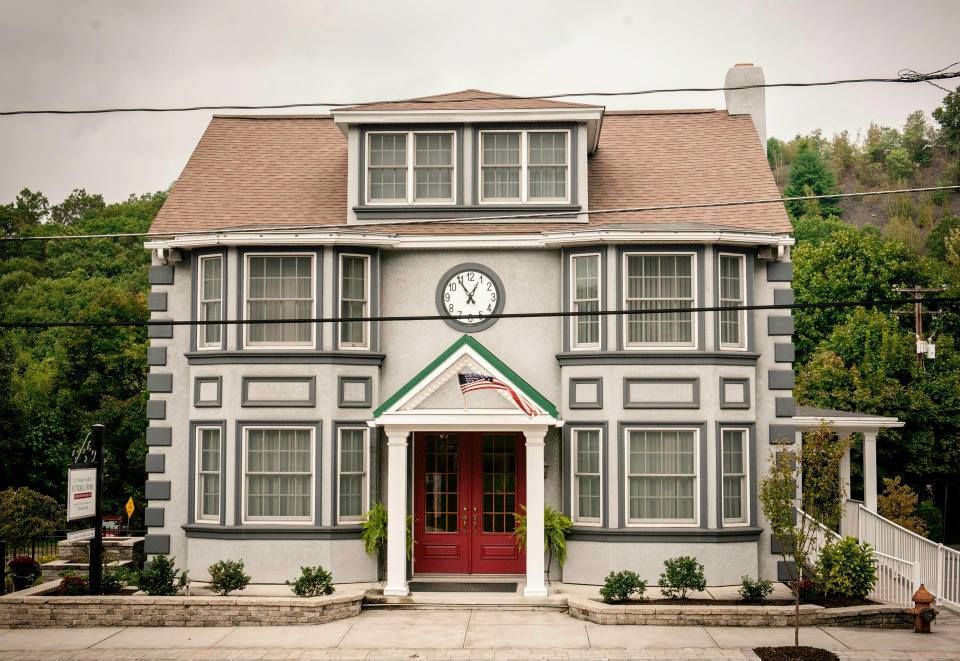 A large house with a clock on the front of it