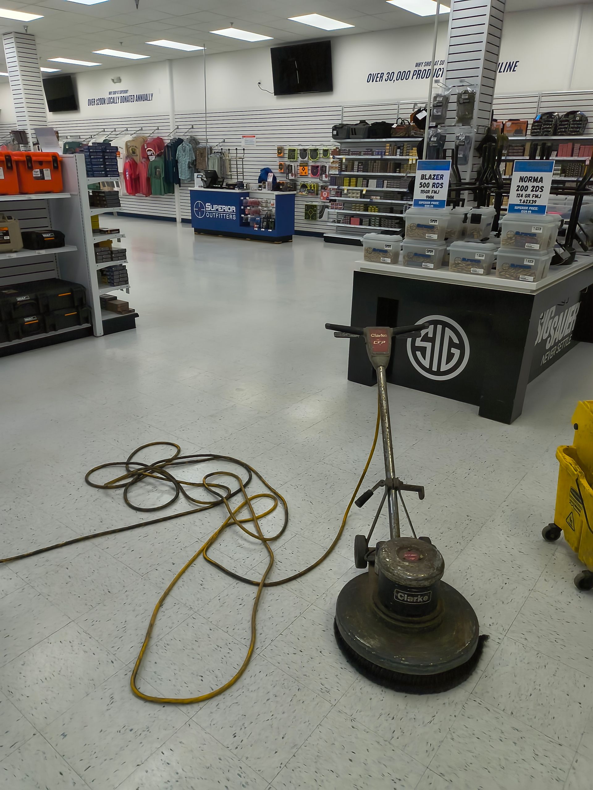 Floor buffer in a retail store, next to a display table with a 