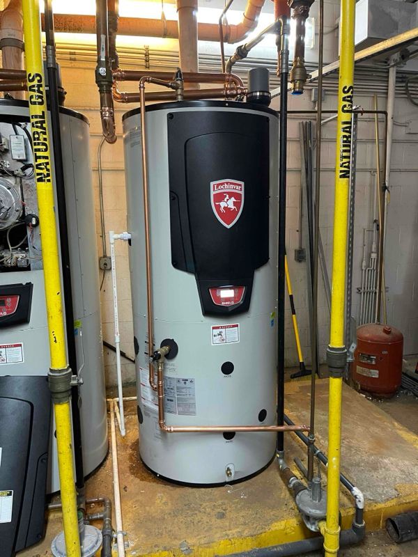Water heater with copper pipes in a utility room, labeled 