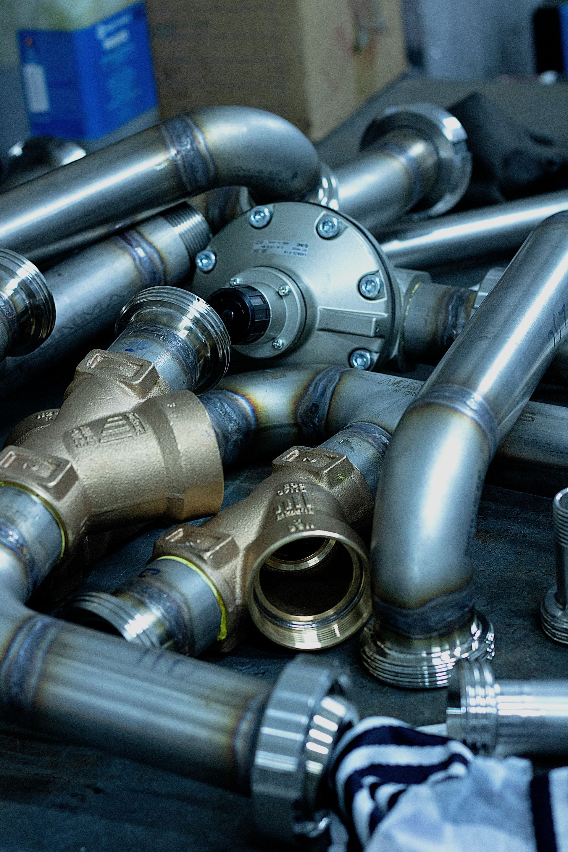 A man is working on a valve in a factory.