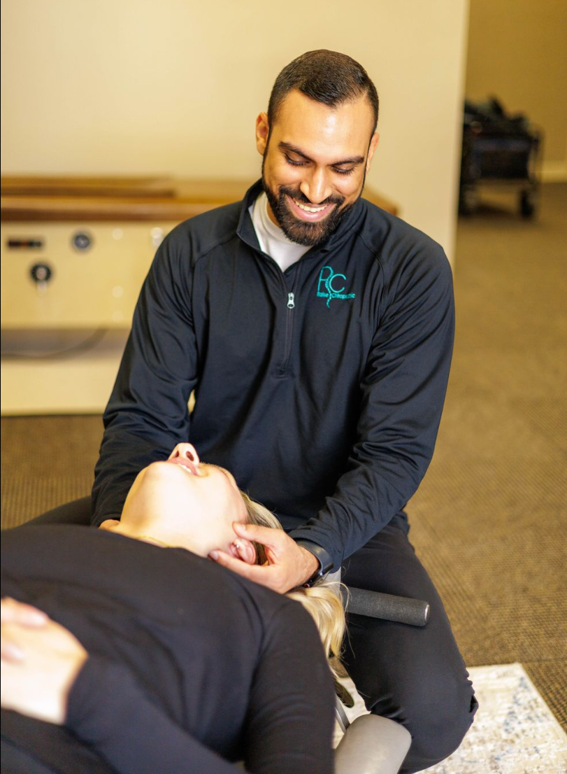 Dr. Neal Surani performing a cervical chiropractic adjustment at Raise Chiropractic