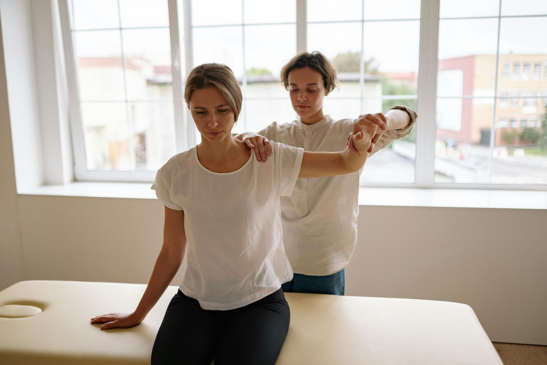 Female getting acupuncture in upper back.