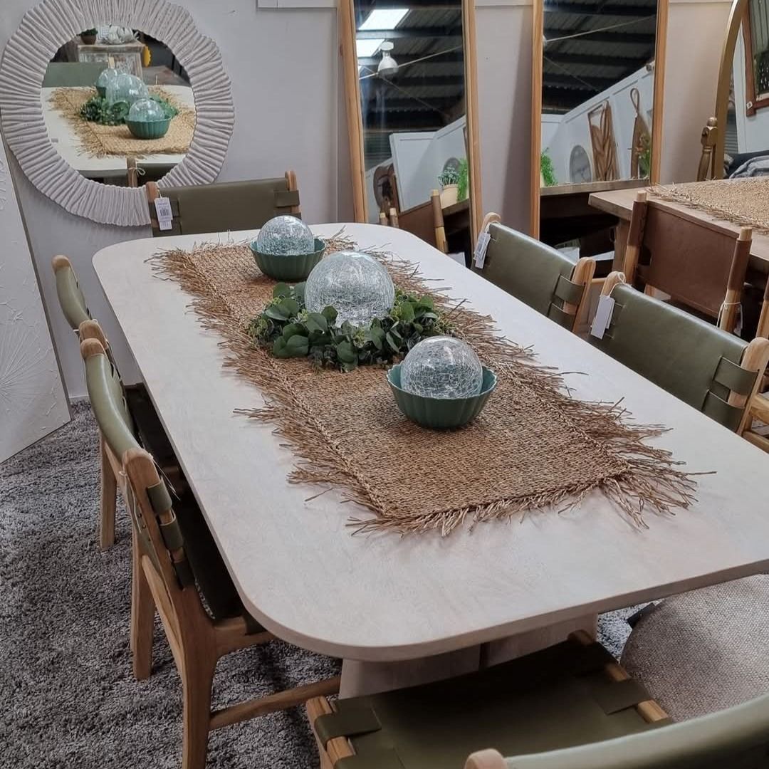 A white table and chairs in a living room