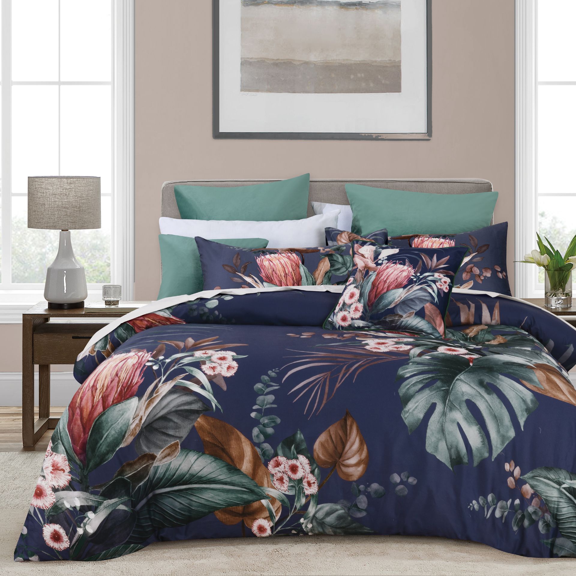 A bed with a comforter and pillows on it in a bedroom.