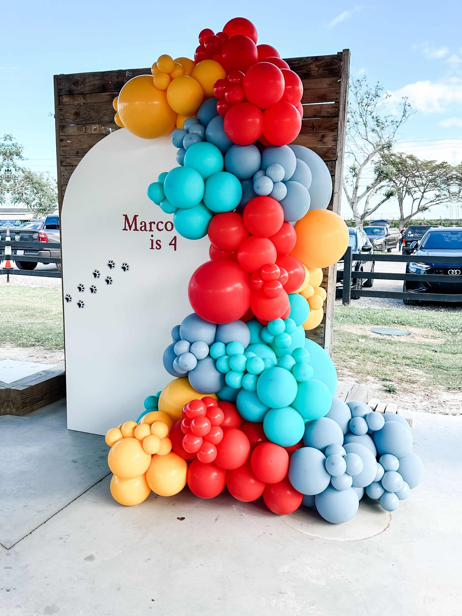 A bunch of colorful balloons are stacked on top of each other