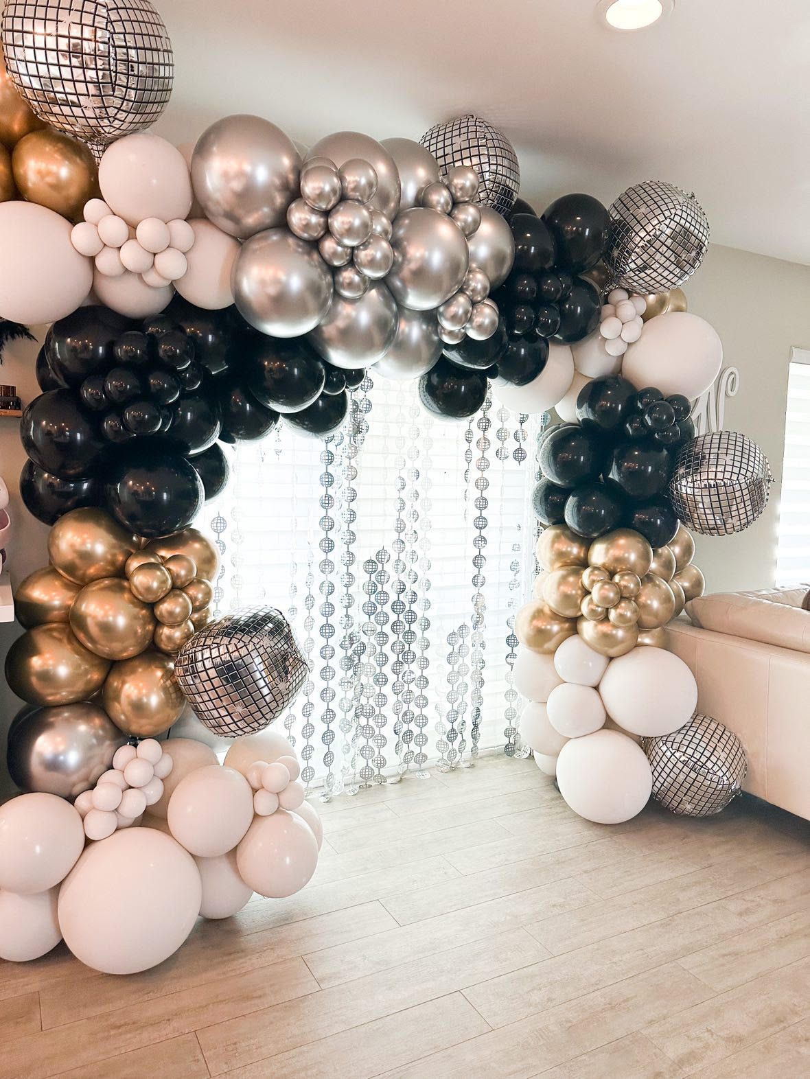 A room filled with lots of balloons and a chair.