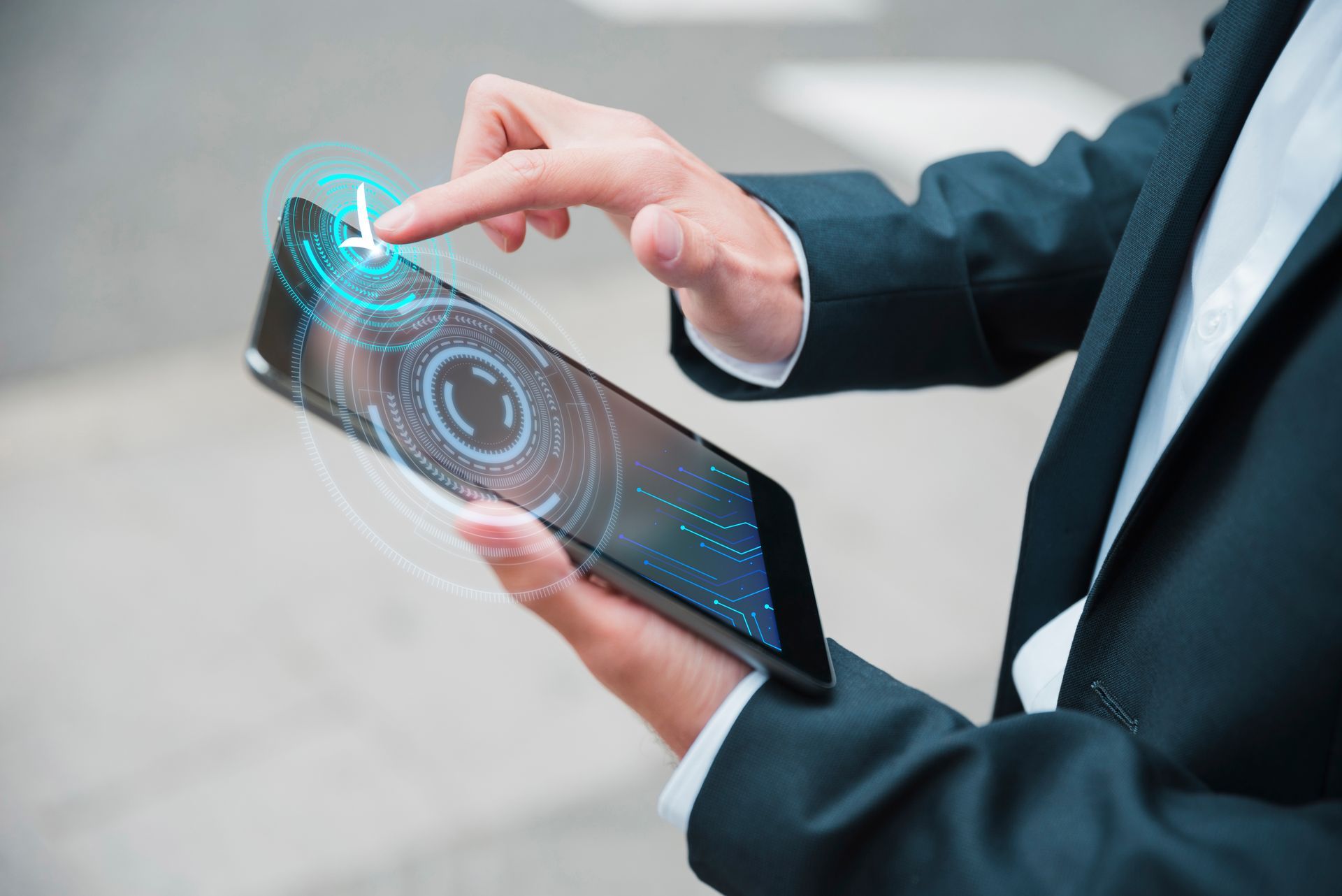 Data-driven performance for group captives. A professional in a suit interacting with a digital tablet displaying futuristic holographic interfaces, symbolizing data-driven risk management and the tracking of leading safety indicators in construction.