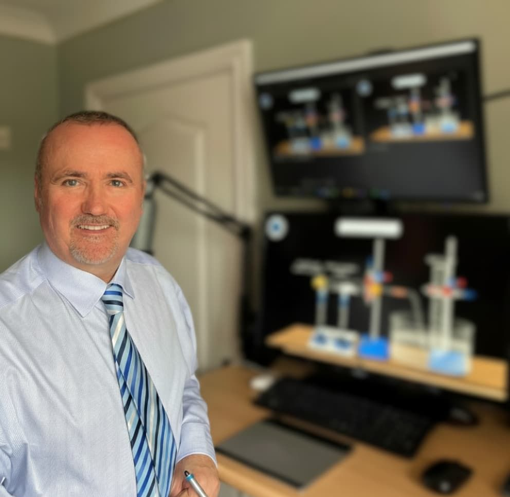 Nigel Straney, a professional A-Level Chemistry examiner, in his office with his online teaching setup.
