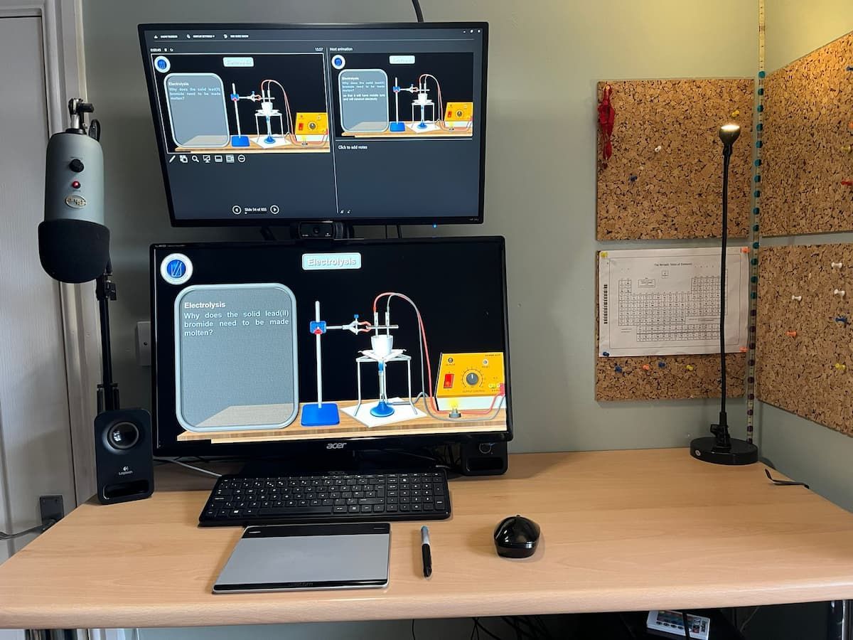 The professional online teaching setup for Simply Chemistry, showing a lesson on electrolysis on dual monitors.