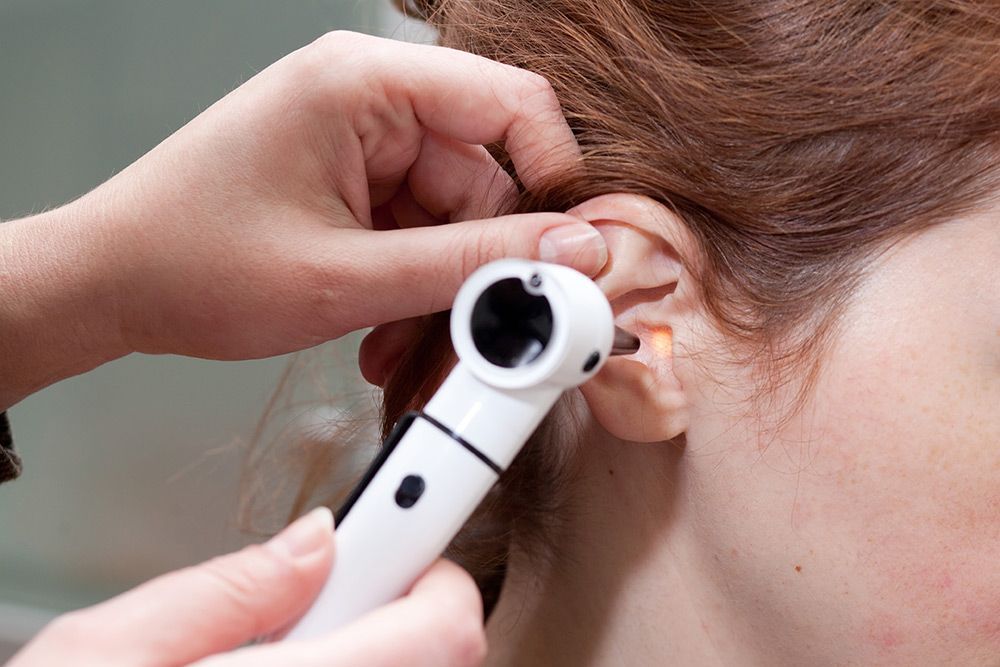 Doctor Examining a Patient's Ear with An Otoscope — Simply Clear Ear Care in Tinonee, NSW 