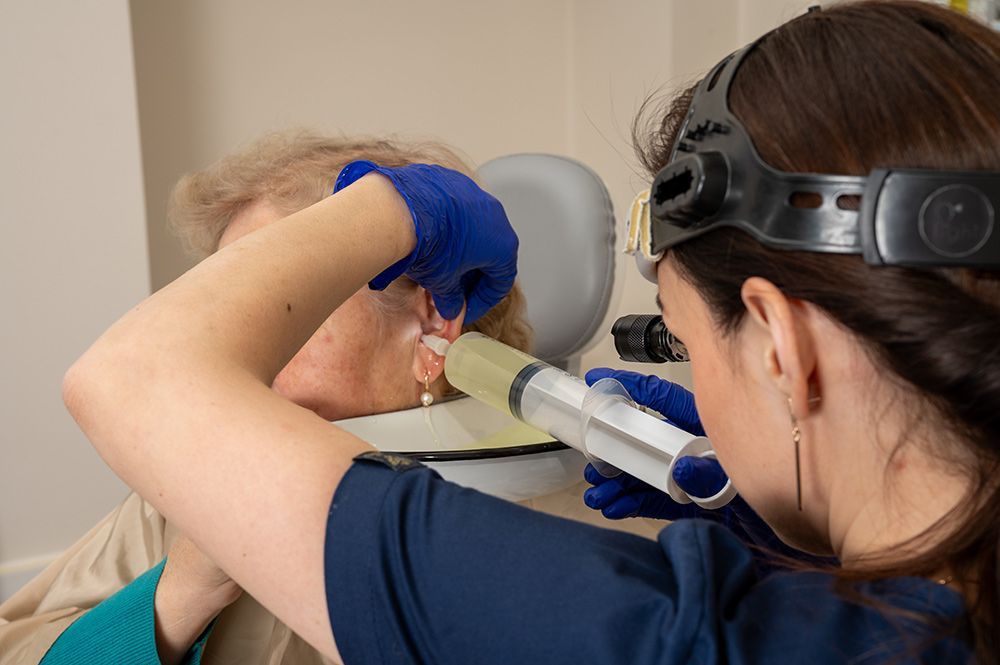 Medical Professional Flushing an Elderly Woman's Ear — Simply Clear Ear Care in Tinonee, NSW 