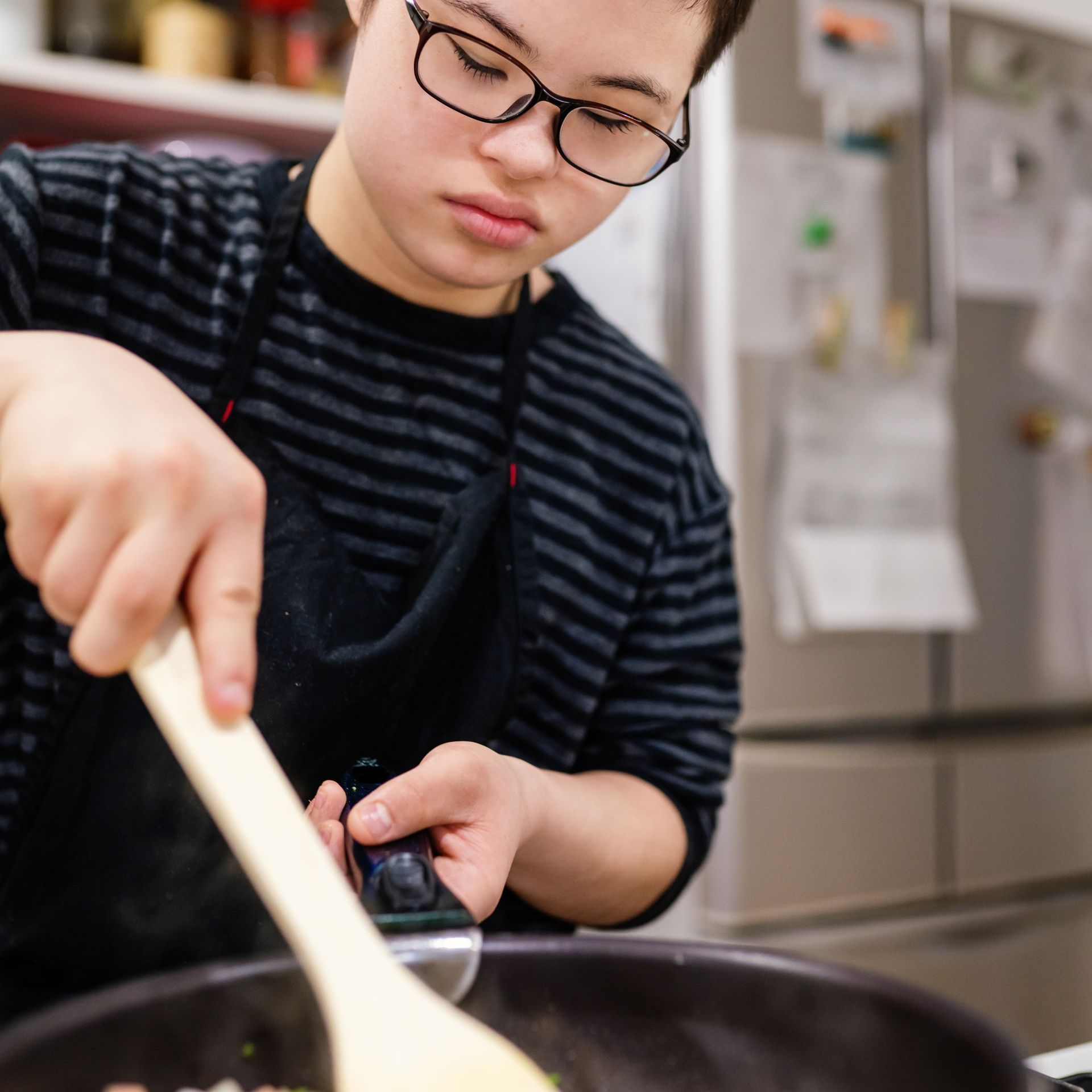 Young man with disability cooking