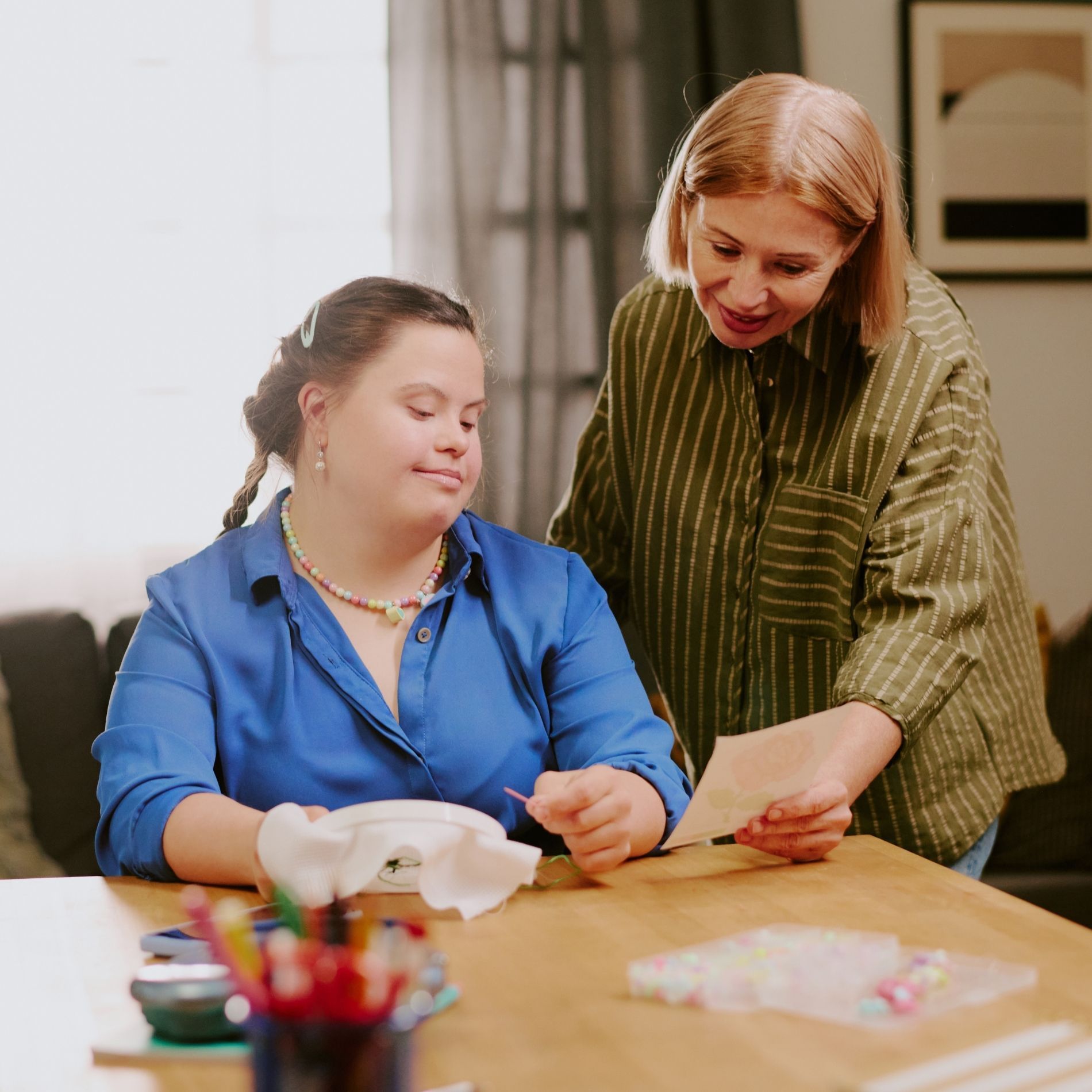 A woman is holding a clipboard next to a nurse