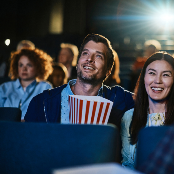 Man and woman sitting inside cinema