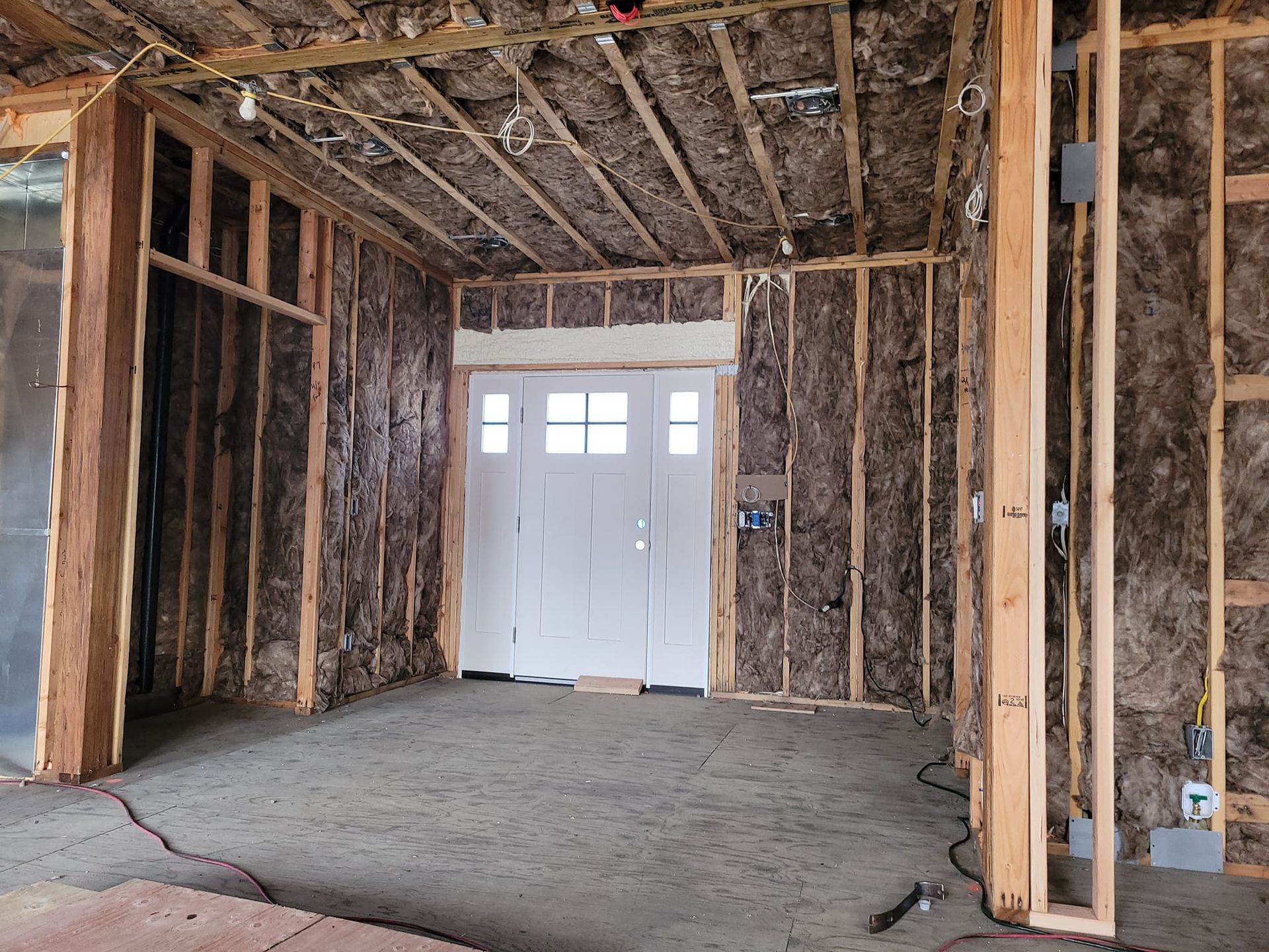 The inside of a house under construction with a garage door