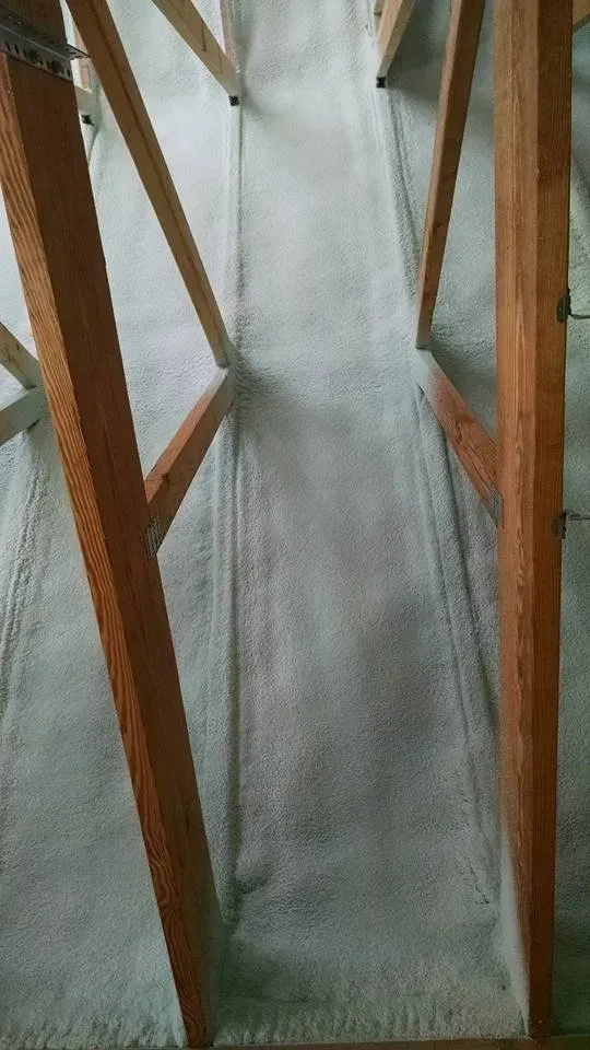 A wooden frame is sitting on top of a white carpet.