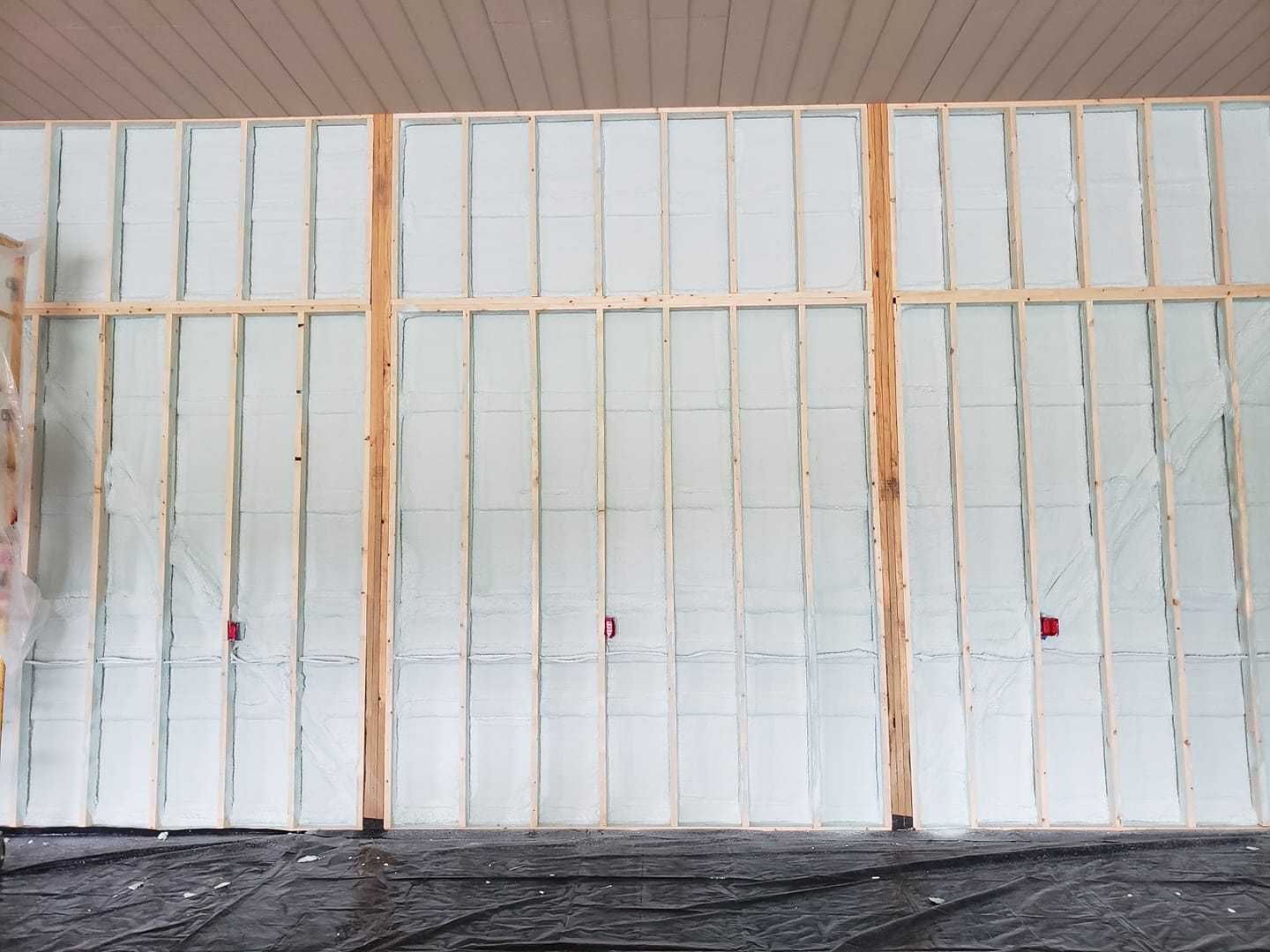 A room with a wooden frame and a lot of insulation on the wall.