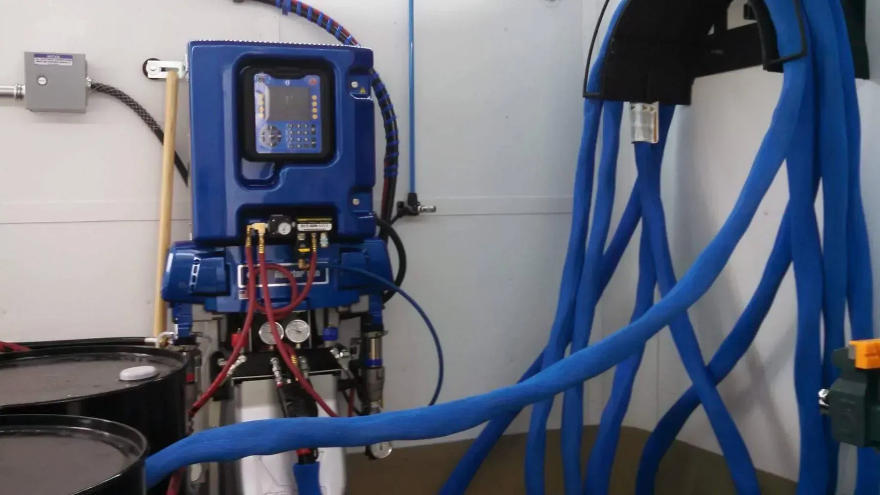 A machine with a blue hose attached to it