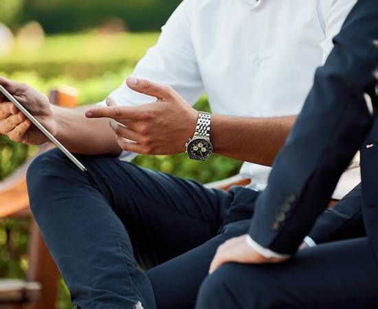 Man showing a something on his tablet screen