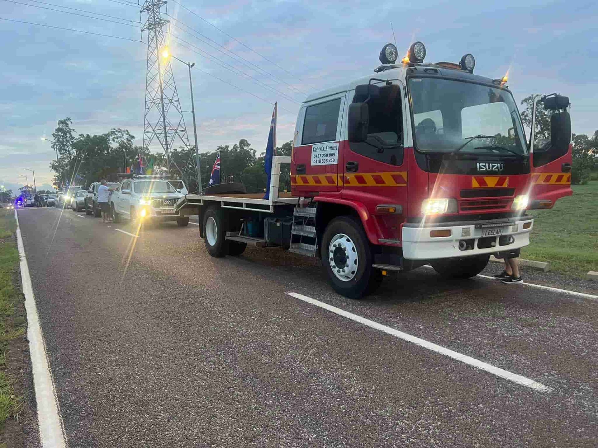 A Red Tow Truck is Parked on the Side of the Road — Cohen’s Towing & 4WD Recoveries In Winnellie, NT