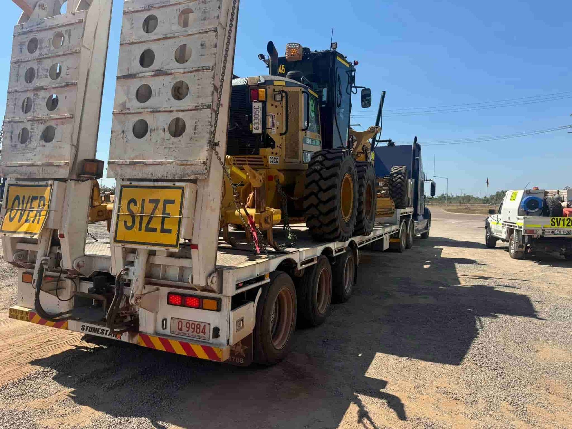 A Large Tractor is Being Transported on a Flatbed Trailer — Cohen’s Towing & 4WD Recoveries In Winnellie, NT