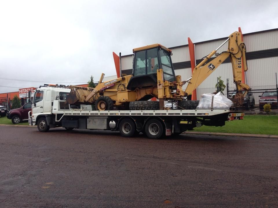 A Yellow Excavator is Sitting on Top of a Flatbed Truck — Cohen’s Towing & 4WD Recoveries In Katherine, NT