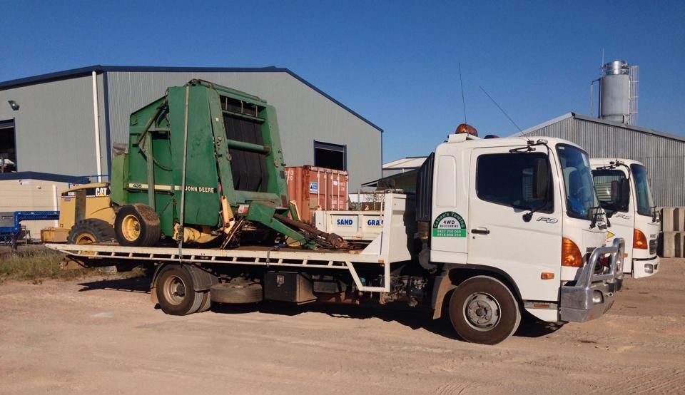 A Tow Truck With machinery on the Back is Parked in Front of a Building — Cohen’s Towing & 4WD Recoveries In Katherine, NT