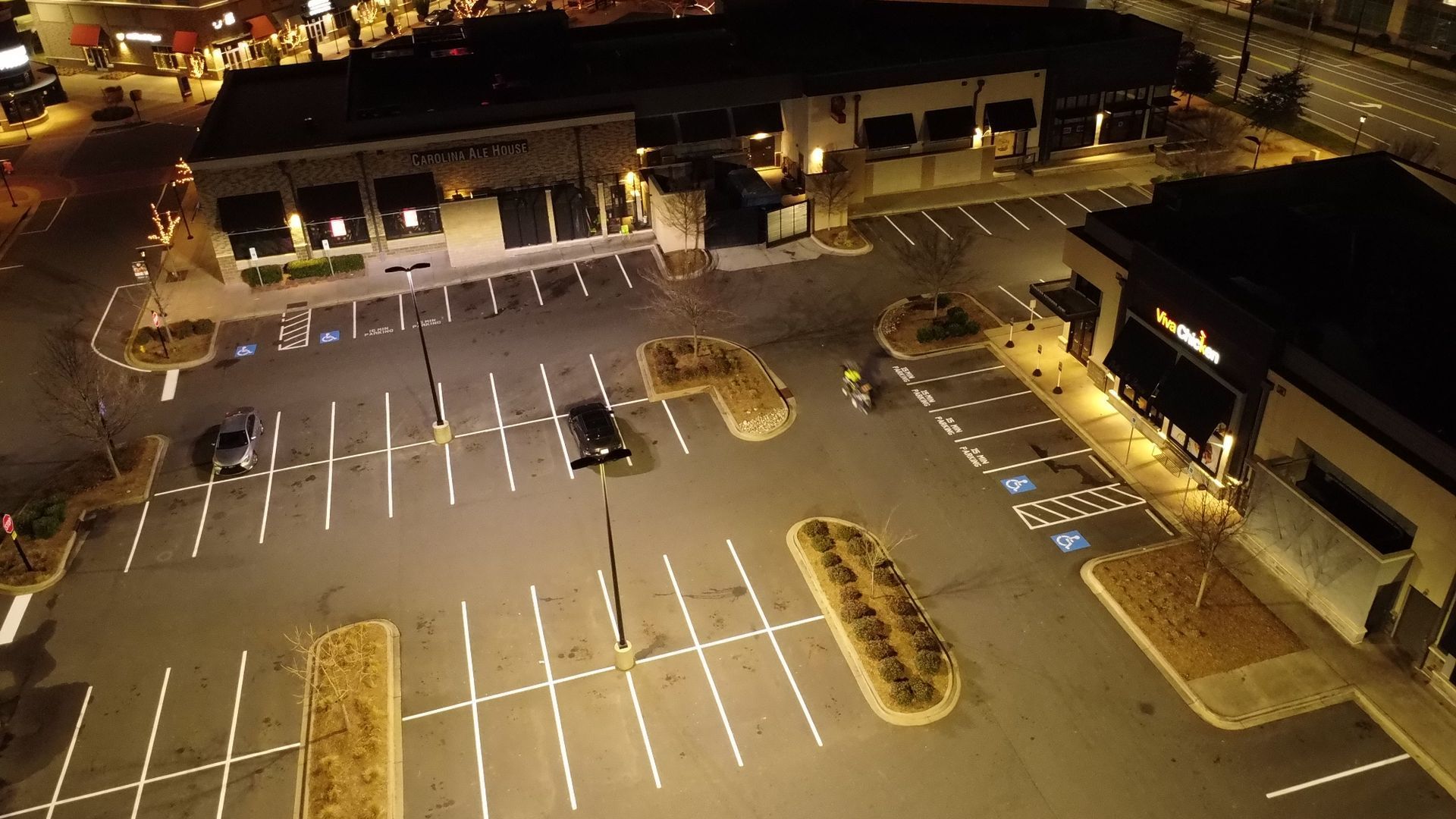 An aerial view of a parking lot at night.
