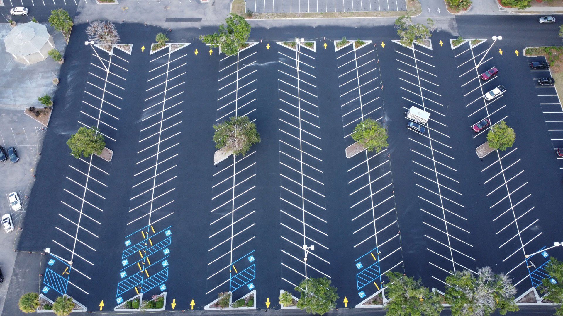 An aerial view of a parking lot with cars parked in it