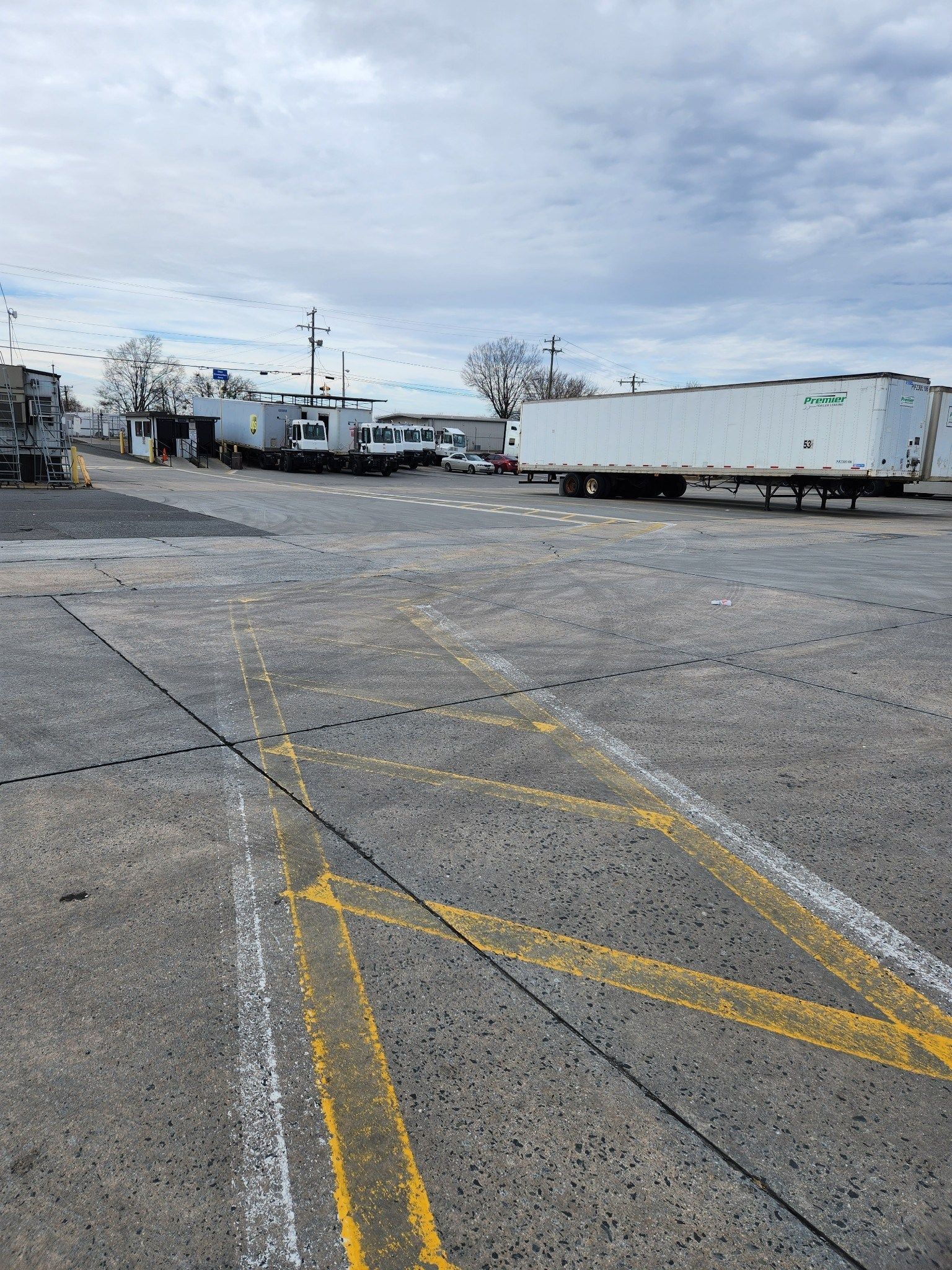 A lot of trucks are parked in a parking lot.